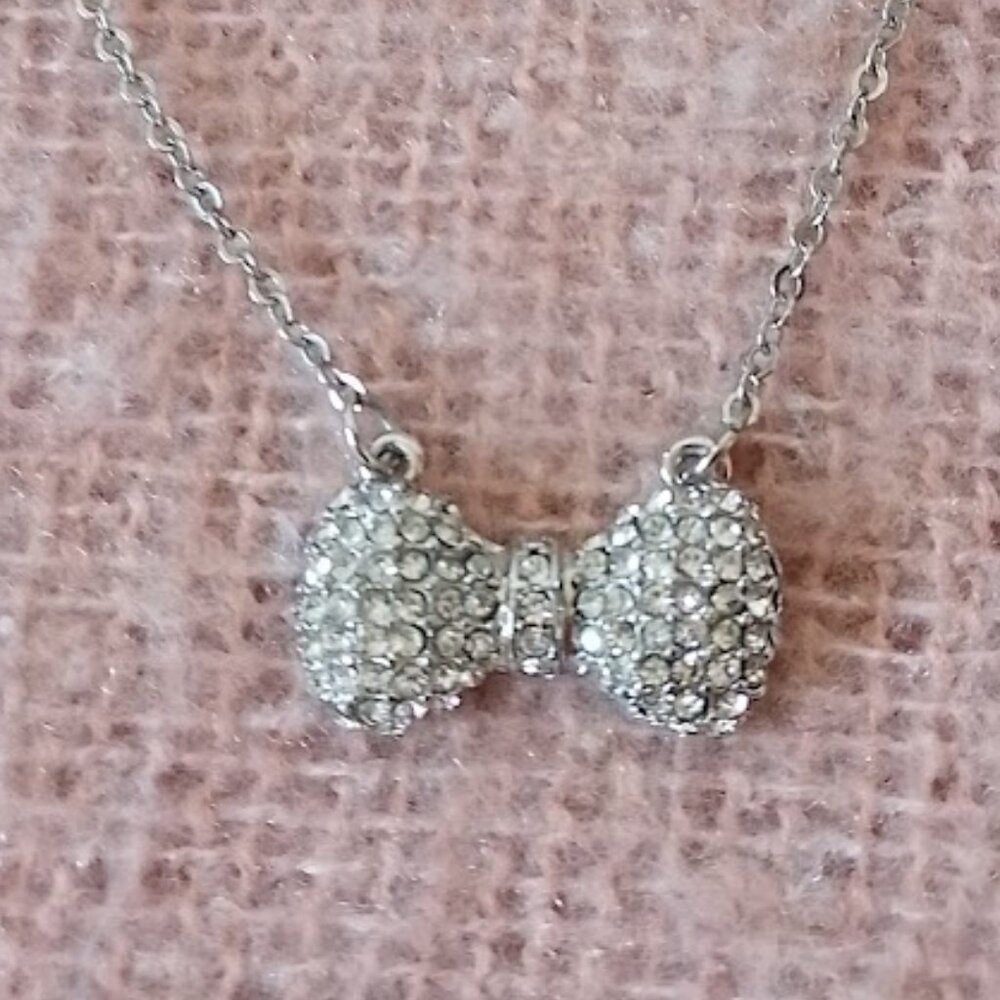 Betsey Johnson Silver Tone Necklace with Rhinestone Bow Pendant